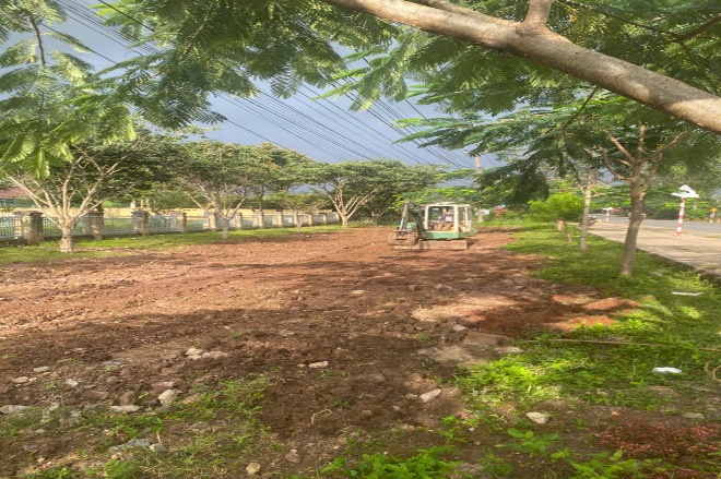 'A tractor on a dirt road
Description automatically generated'